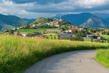 Sticker - Postcard from Provence. Sunny alpine valley with old town on the hill top.