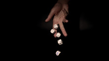 Hand Throwing Gambling Dice On  Table, Black Background 