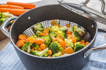 Steamed mixed vegetable in black pot. Healthy vegetable concept