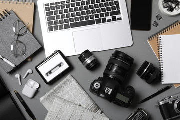 Wall Mural - flat lay composition with equipment for journalist on grey table