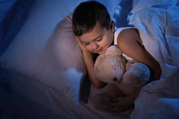 Canvas Print - Little boy sleeping with teddy bear at home. Bedtime