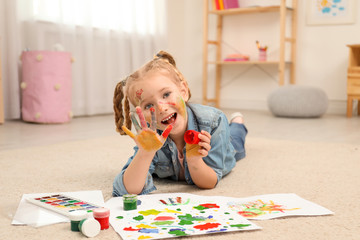 Sticker - Cute little child painting with palms at home