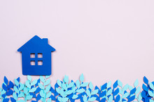Paper Blue House With Blue Paper Flowers On A Pink Background