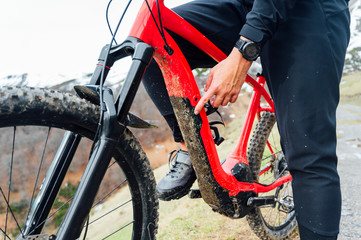 Man connecting an electric mountain bike