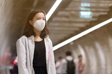 Asian travelers girl with medical face mask to protection the coronavirus in public areas