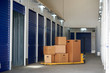 © PHILIPPE DEGROOTE/ADDICTIVE STOCK - Inside industrial self storage building for rental with blue locked doors