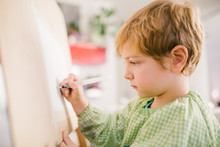 Kid Drawing On Canvas At Home