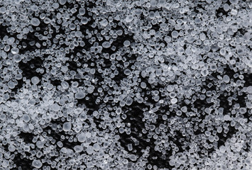 spilled white food salt on a black background.