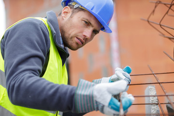 concentrated builder using bubble level at construction site