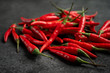 pile of Red chili peppers on a black stone, close up
