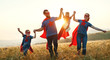 © JenkoAtaman - concept of super family, family of superheroes at sunset .