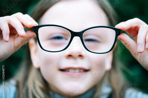 Cuadros en Lienzo Closeup portrait of little girl with myopia correction glasses
