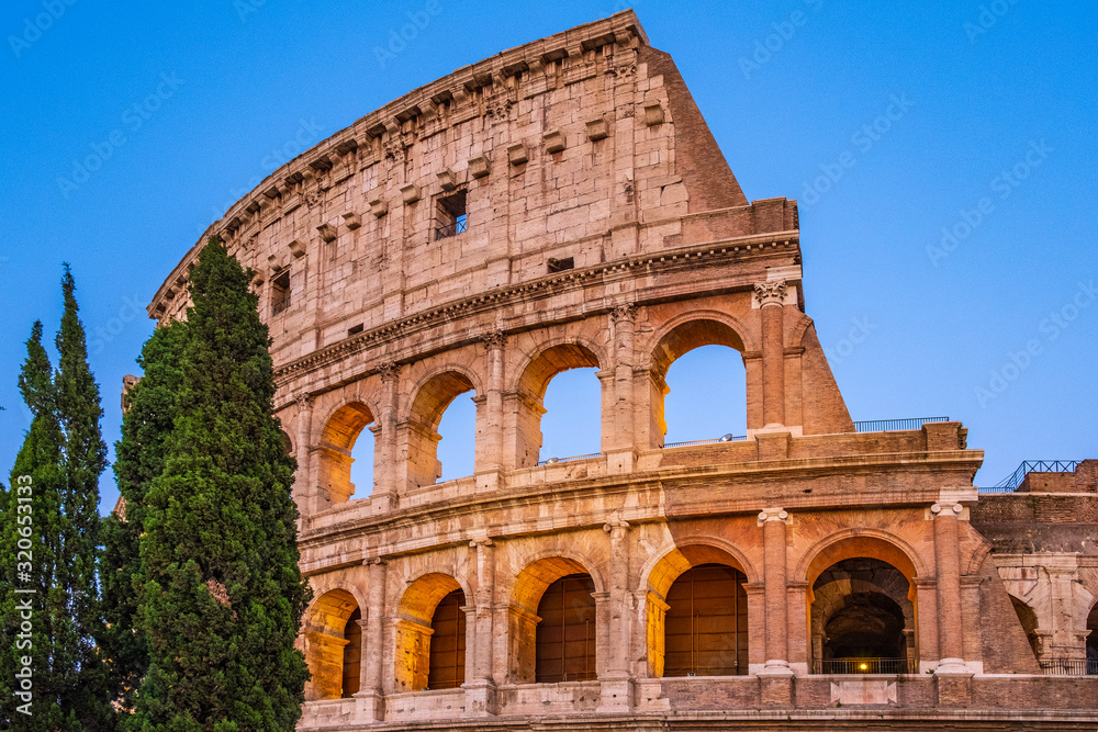 Rome, Italy - External walls of the ancient roman Colosseum - Colosseo - known also as Flavian amphitheater - Anfiteatro Flavio - in an evening light - obrazy, fototapety, plakaty 