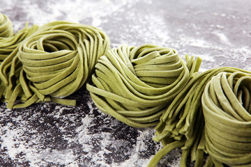 Closeup of raw homemade pasta tagliatelle. fresh italian traditional raw fresh green organic pasta