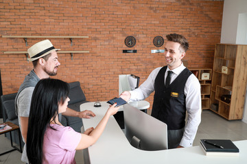 Poster - Couple booking room in hotel at reception