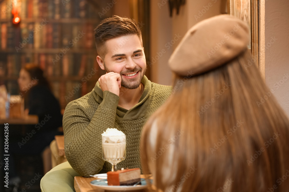 Happy young couple on romantic date in cafe