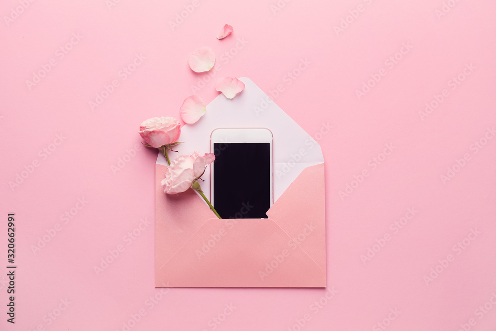 Composition with envelope, mobile phone and flowers on pink background