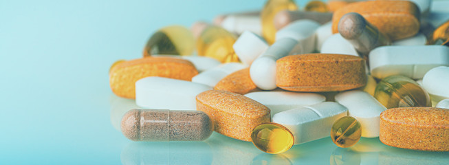 Wall Mural - Panoramic macro photo of medication pills, medicine tablets, dietary supplements or drugs with copy space, toned