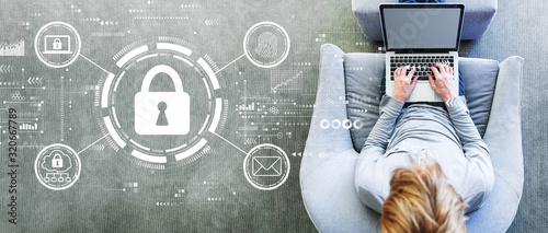 Fotografía Internet network security concept with man using a laptop in a modern gray chair