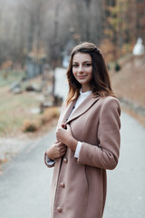 Outdoor portrait of a young beautiful confident woman posing in the street. Model. Female fashion concept. Beauty girl with hairstyle and make up. Concept of fashion.