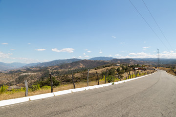 Road with mountains landscape and rural area - road to Quiche in Guatemala