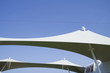 Modern design awning on cruiseship or cruise ship liner providing shadow on sun deck with clean lines against blue sky