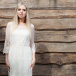 © Unique Vision - Portrait of beautiful young girl on wooden background.