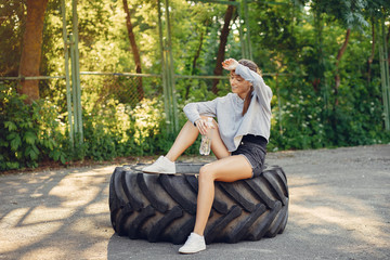 Wall Mural - Beautiful girl in a park. Sports girl in a sportswear.