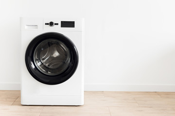 White laundry room with a washing machine Copy space