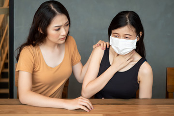 women with face mask from flu infection, sore throat; concept of Wuhan virus, corona virus, H5N1 H1N1, bird flu, pig influenza, pneumonia, lung inflammation, epidemic fever, pandemic outbreak