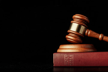 Wall Mural - judge gavel with holy bible on black background
