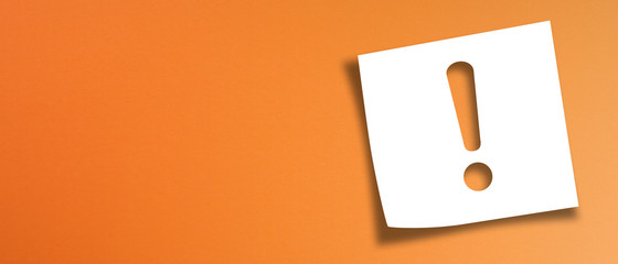 note paper with exclamation mark on panoramic orange background