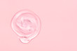 Clear gel drop or smear isolated on pink background.