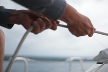 Close Up Of Hands Coiling Up A Rope, Sheet On A Sailboat