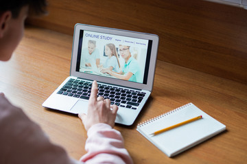 Poster - Laptop with image of schoolkids on screen and college student touching button of keypad while surfing in the net