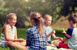 © Syda Productions - summer holidays, entertainment, childhood, leisure and people concept - group of happy pre-teen kids playing rock-paper-scissors game in park
