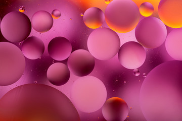 photo, bright oily drops in water with colorful background, close-up 