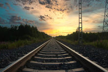 Long Railroad Track Leading Into A Beautiful Sunset. 