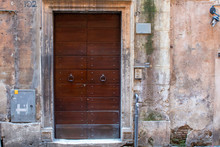 Ancient Wooden Door In Old Stone Wall. Old Medieval Wooden Door In A Stone Wall.
