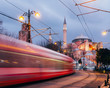 Istanbul, Turkey - Jan 9, 2020: A T1 tram passes the Hagia Sophia museum at dusk, Istanbul, Turkey