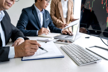 Poster - Business team partner working with computer, laptop, discussion and analyzing graph stock market trading with stock chart data planning, financial and investment concept