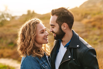 Wall Mural - image of beautiful couple dating and walking together in countryside