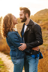 Wall Mural - image of beautiful couple dating and walking together in countryside