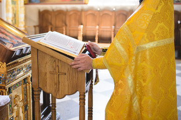 praying priest at church