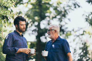 Old father and son, Morning coffee in a garden