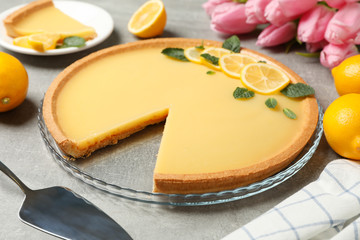 Wall Mural - Composition with lemon tart on grey background, close up