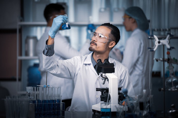 Wall Mural - team of medical research scientists collectively working on a new generation experimental drug treat