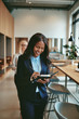 © Flamingo Images - Smiling African American businesswoman walking in an office taki
