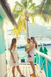 © Brocreative - A smiling cute family enjoying a Caribbean Cruise vacation together. Candid photo of a young family talking together with a Cruise ship in the background