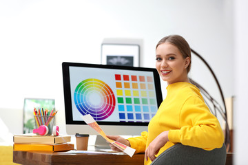 Poster - Professional designer with color palettes at workplace in office